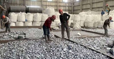 Workers crush silicon metal in the Jingang Circular Economy Industrial Park in Yili prefecture, Xinjiang. China