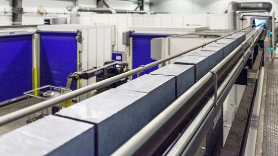 Bricks of upgraded metallurgical-grade (UMG) silicon on a conveyor belt in the factory of REC Solar Norway (formerly Elkem Solar) in Kristiansand, Norway