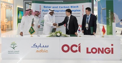 Representatives of Saudi Arabia’s National Industrial Clusters Development Program, Saudi Basic Industries Corp., OCI Company and Longi Group shake hands after signing a Memorandum of Understanding