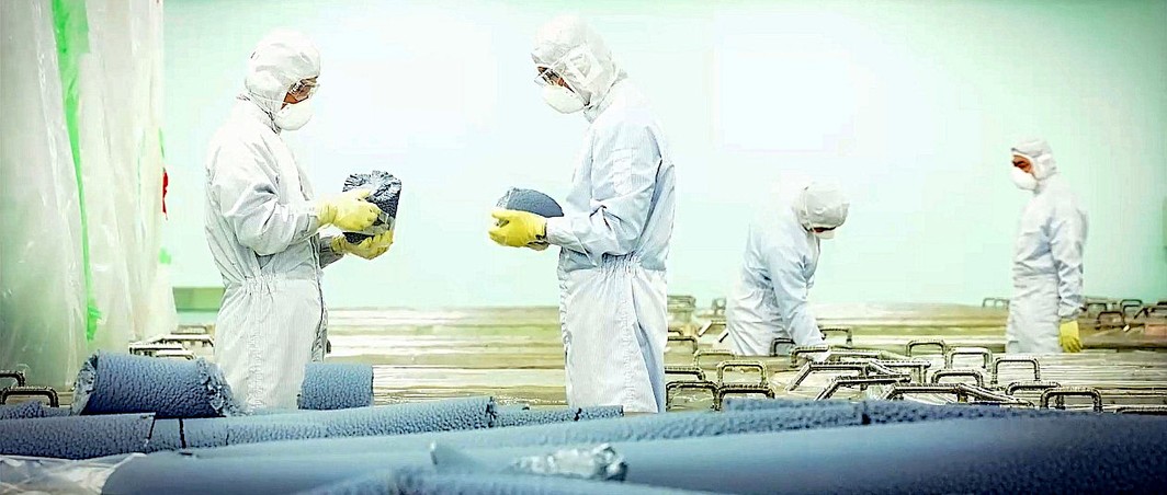 Technicians at OCI Malaysia inspecting polysilicon chunks and rods