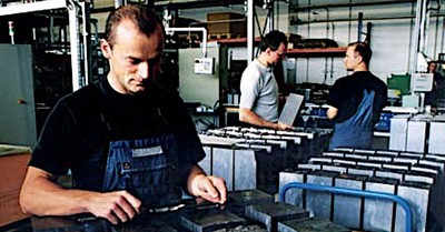 Workers at SolarWorld Industries Sachsen handling silicon bricks