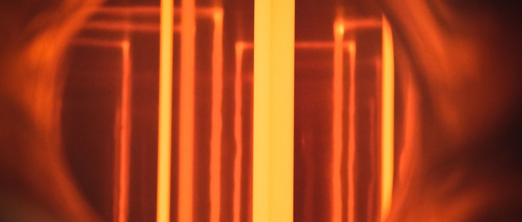 View through a bull’s-eye window into a chemical vapor deposition (CVD) reactor with glowing silicon rods for producing hyper-pure polysilicon from trichlorosilane (Siemens process)