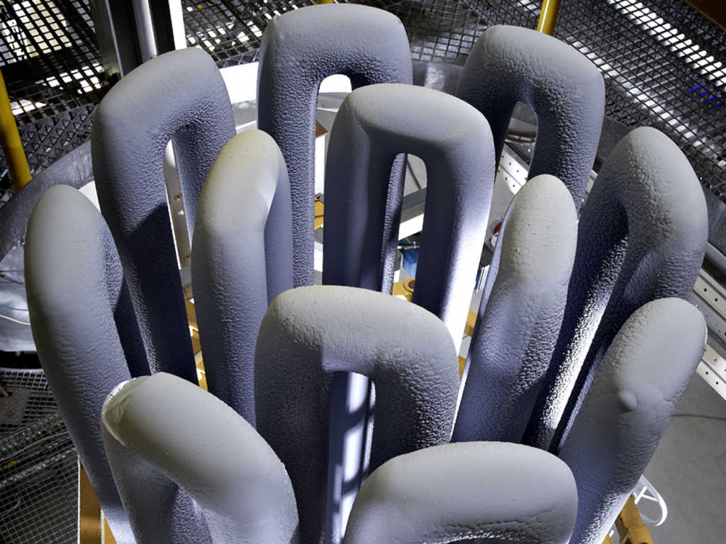 Grown polysilicon rods after the steel bell jar of the chemical vapor deposition (CVD) reactor has been lifted